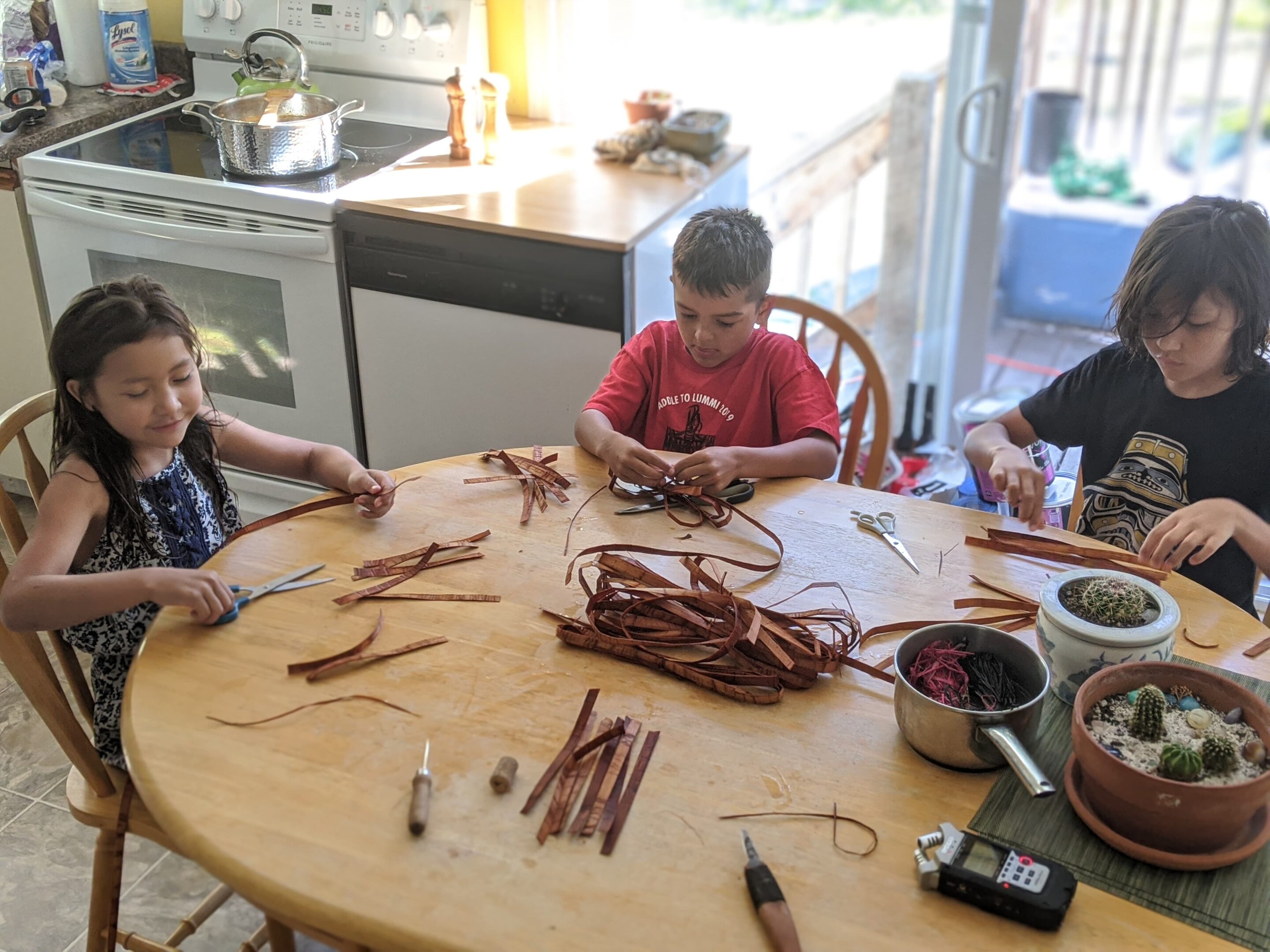 Tla'amin weaver Sosan Blaney teaching a class to youth with soundscapes of Indigenous artists