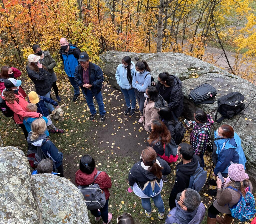 Group of visitors your and r eceive information about Tse'k'wa formerly Charlie Lake Caves