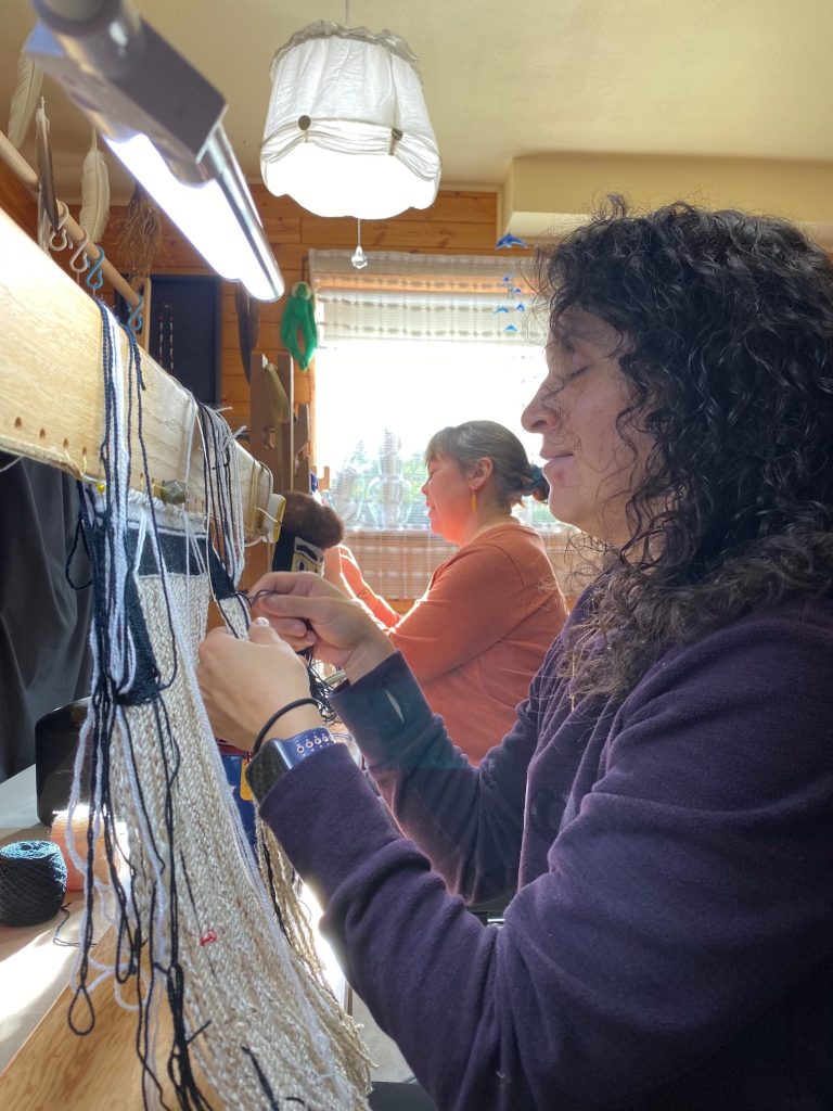Tina Robinson and Pearl Innis weaving together