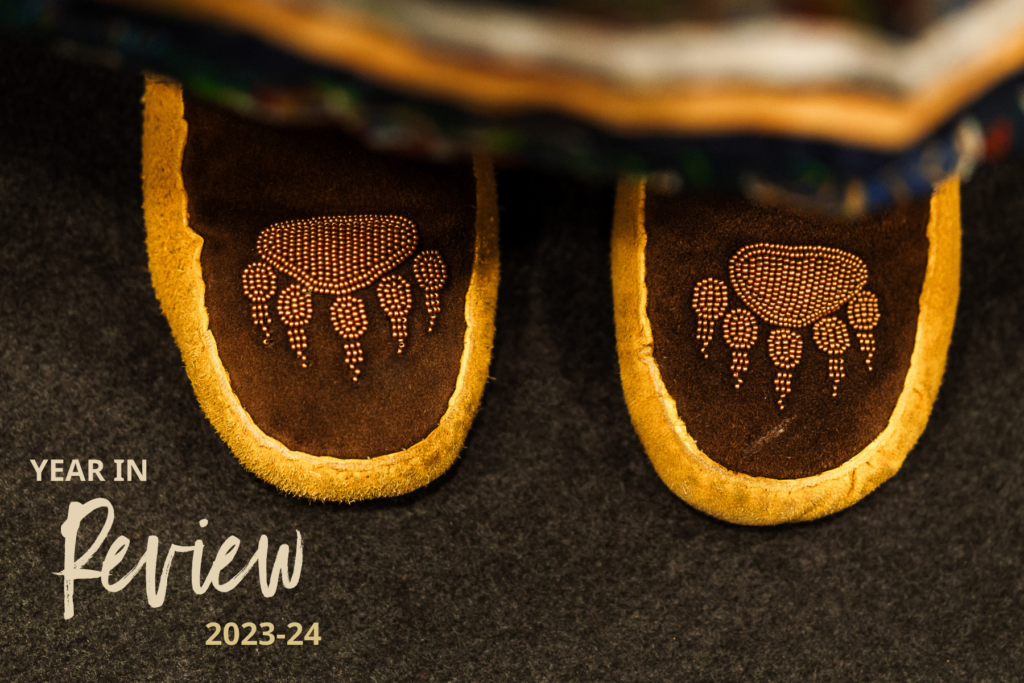 Annual Report cover: a child's brown beaded moccasins are shown up close